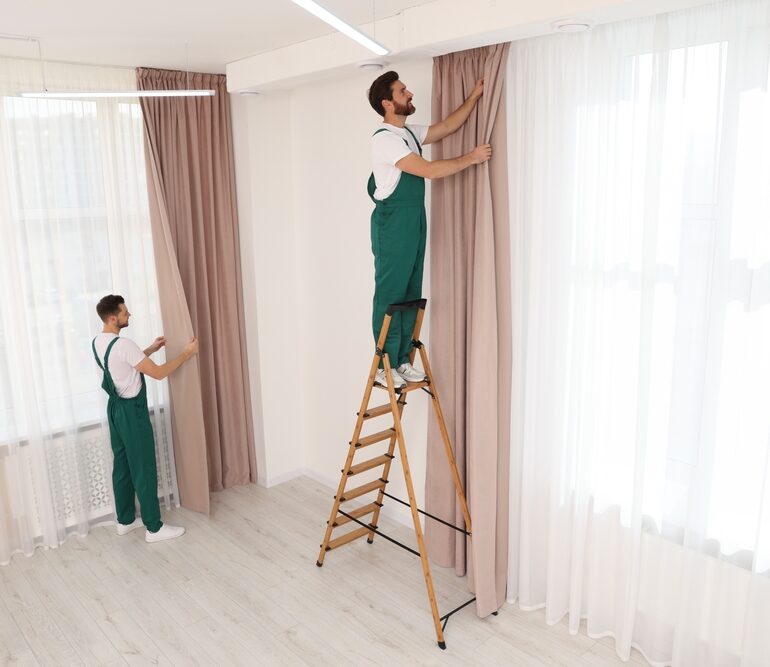 Workers,In,Uniform,Hanging,Window,Curtain,Indoors